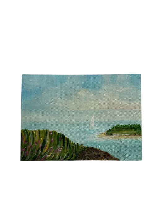 Small painting of a coastal landscape with green hills and blue sky.